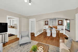Living area featuring wood finished floors and arched walkways