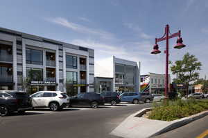 View of building exterior with uncovered parking