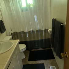 Full bathroom featuring vanity and shower / bath combo with shower curtain