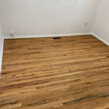 Detailed view of wood finished floors and baseboards