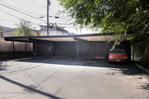 Rear view of property featuring covered parking