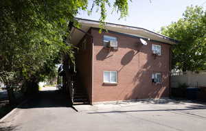 View of side of property with stairs and brick siding