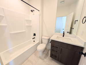 Bathroom with vanity, washtub / shower combination, and tile patterned floors