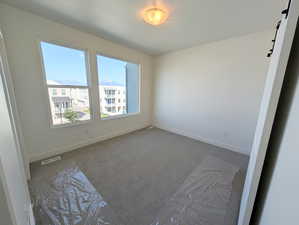 Empty room with carpet floors and a barn door