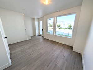 Spare room with baseboards and wood finished floors