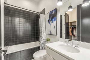 Bathroom featuring tiled shower / bath combo and vanity