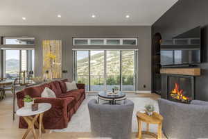 Living area featuring recessed lighting, wallpapered walls, a mountain view, light wood finished floors, and plenty of natural light
