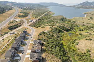 Aerial view of property and surrounding area featuring a water and mountain view