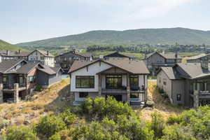 Rear view of house with a residential view and a mountain view