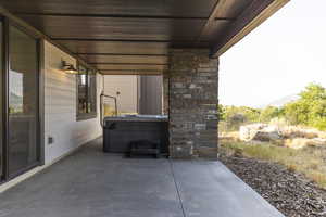 View of patio / terrace with a hot tub