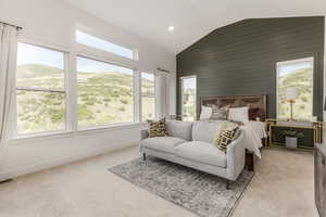 Bedroom featuring wooden walls, recessed lighting, and high vaulted ceiling