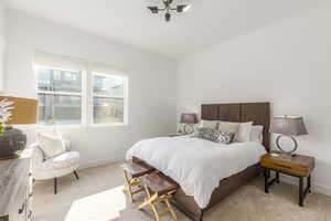 Bedroom featuring baseboards and light colored carpet