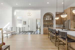 Dining area with recessed lighting, light wood-type flooring, and a chandelier