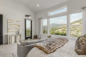 Carpeted bedroom with a mountain view, vaulted ceiling, access to exterior, and recessed lighting
