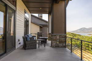 Balcony with a water and mountain view