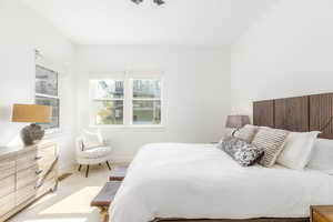 Bedroom featuring baseboards and light carpet