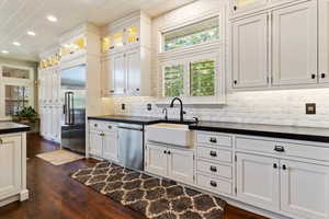 Kitchen featuring dark countertops, decorative backsplash, stainless steel appliances, healthy amount of natural light, and recessed lighting