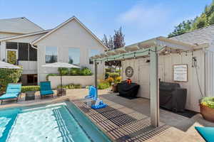 View of swimming pool with a pergola, a patio, and a grill