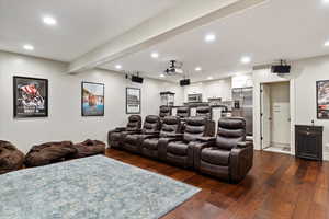 Home theater room with recessed lighting and dark wood-type flooring