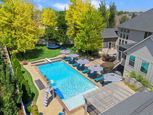 View of swimming pool featuring a trampoline and a patio