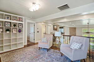 Living area featuring wood finished floors, wooden ceiling, and a chandelier