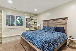 Carpeted bedroom with baseboards and recessed lighting