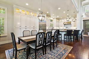 Dining area featuring crown molding, recessed lighting, dark wood-style floors, and a chandelier