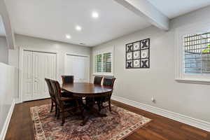 Dining room with recessed lighting, beamed ceiling, and dark wood-style flooring