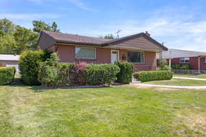 Single story home with brick siding and a chimney