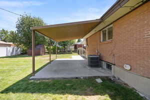 Fenced backyard with a patio and a storage unit