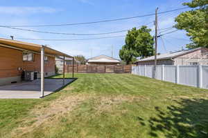 Fenced backyard featuring a patio