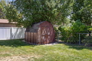 View of shed with a fenced backyard