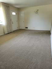 Entryway with carpet flooring and baseboards