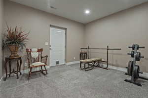 Workout room with carpet and recessed lighting