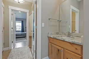 Bathroom featuring vanity, tile patterned flooring, and connected bathroom