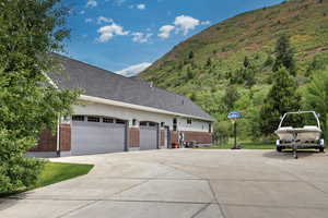View of side of home featuring brick siding and concrete driveway