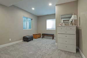 Carpeted bedroom with multiple windows and recessed lighting