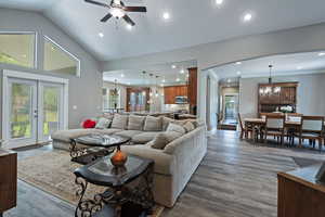 Living area with french doors, recessed lighting, dark wood-style flooring, a ceiling fan, and high vaulted ceiling