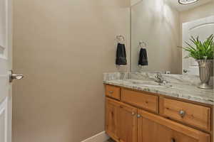 Bathroom with vanity and baseboards