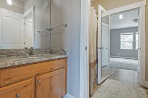 Full bath featuring vanity, tile patterned flooring, and curtained shower