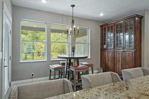 Dining space featuring a chandelier and recessed lighting