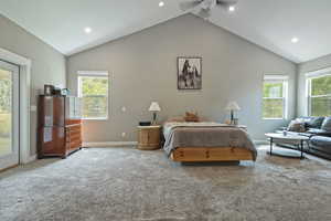 Carpeted bedroom with vaulted ceiling, recessed lighting, and access to exterior