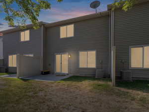 Rear view of house featuring a lawn and a patio area