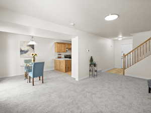 Living room featuring stairway and light carpet