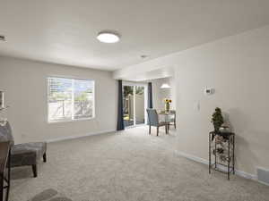 Sitting room with carpet flooring and baseboards