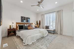 Carpeted bedroom with recessed lighting and ceiling fan