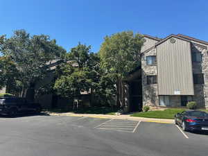 View of building exterior with uncovered parking