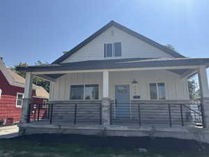View of front of home featuring board and batten siding and covered porch