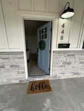 View of exterior entry with brick siding
