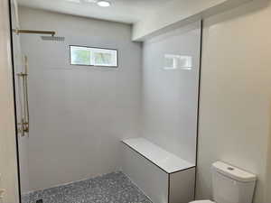 Full bath featuring tiled shower